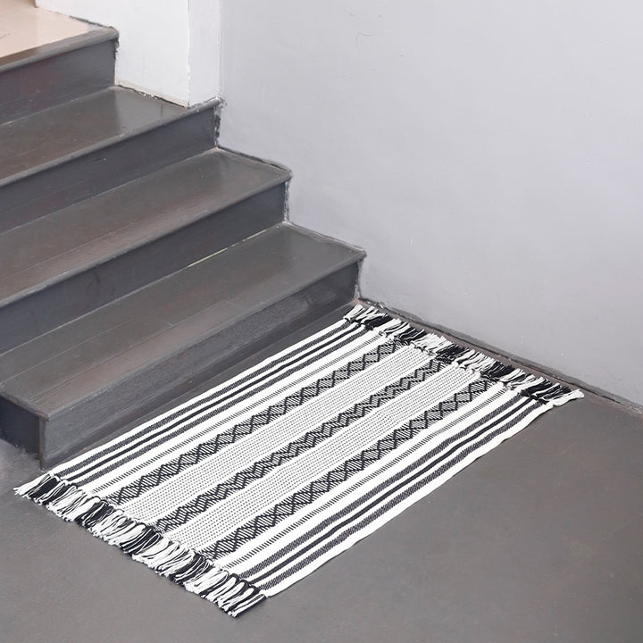 Flat-woven cotton runner with fringes and graphic ethnic stripe pattern