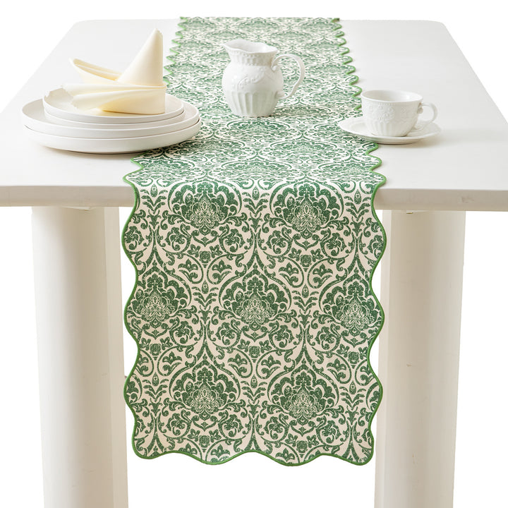 Elegant table runner with wavy hem and baroque damask pattern