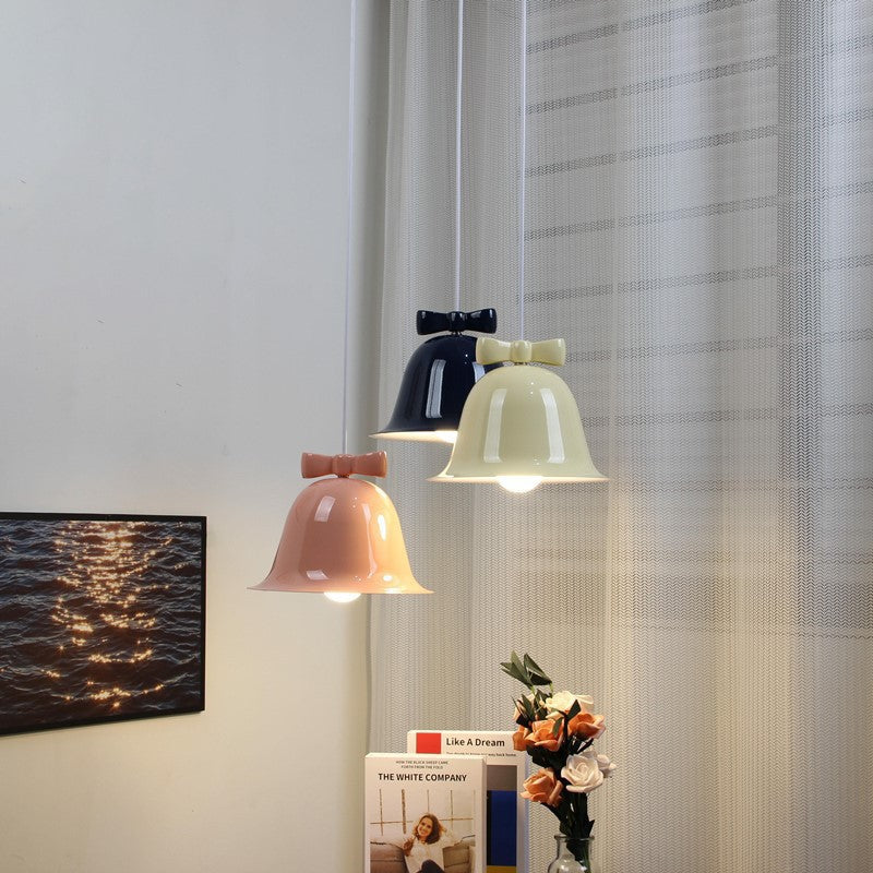 Bell-shaped glass pendant lamp with decorative bow accent