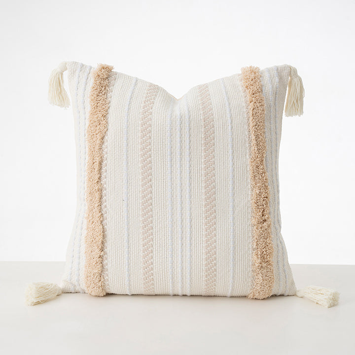 Square decorative cushion with boucle stripes, woven texture, and corner tassels