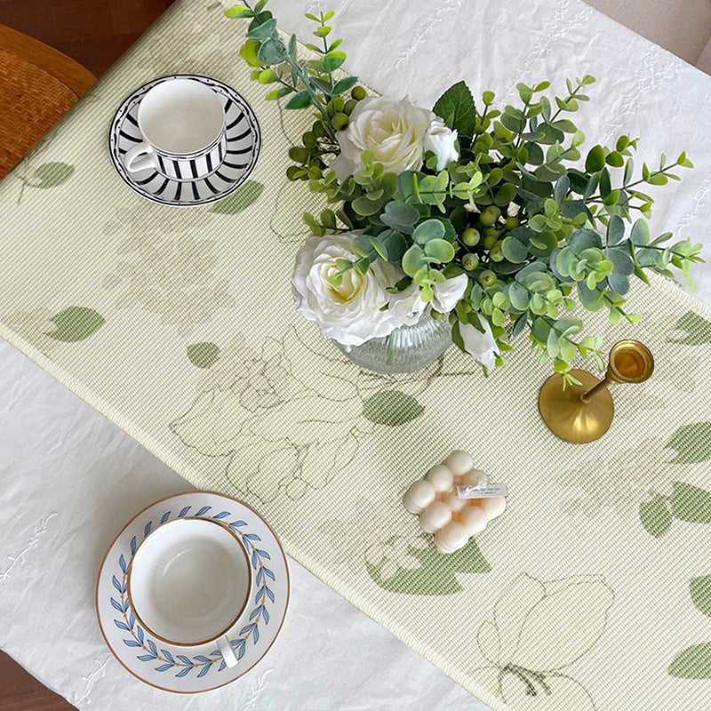 Woven table runner with floral jacquard pattern and fringed edge
