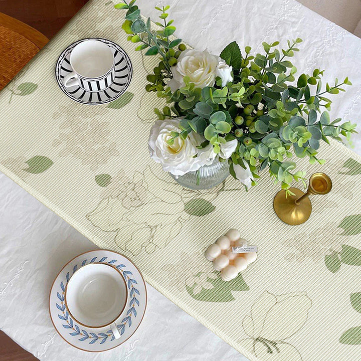 Woven table runner with floral jacquard pattern and fringed edge