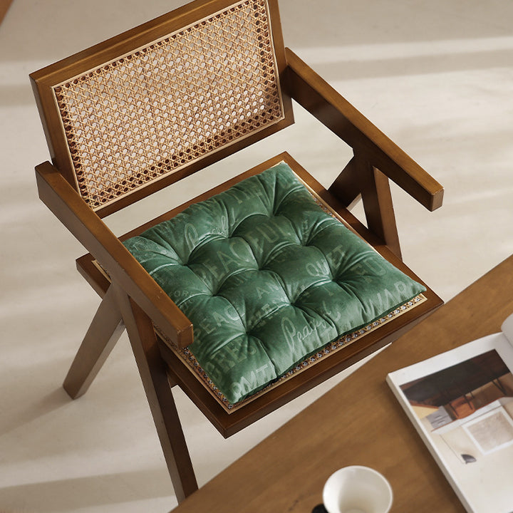 Padded upholstered chair cushion with quilting and fastening straps