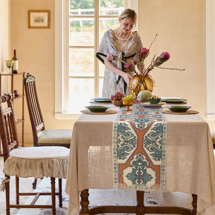 Woven table runner made of cotton blend with oriental medallion pattern and fringes