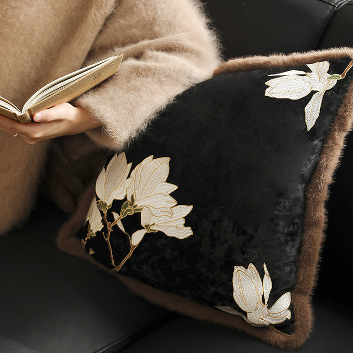 Square velvet decorative cushion with embroidered magnolia motif and faux fur border