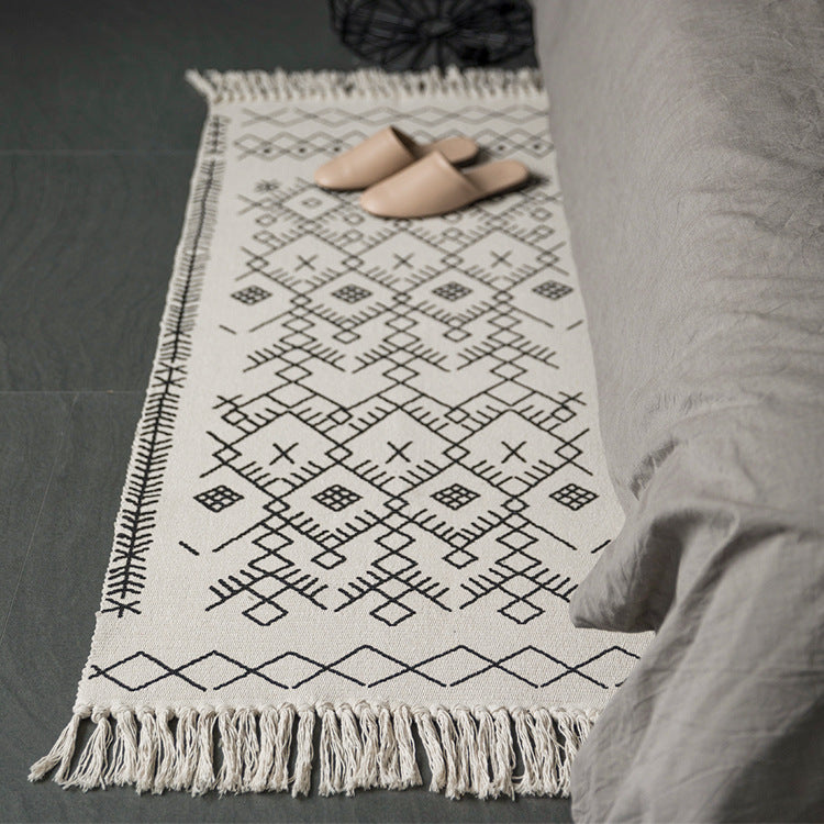 Woven cotton rug runner with flat weave structure, graphic diamond ethnic pattern and fringes