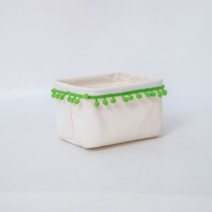 Storage basket with decorative pom-pom trim