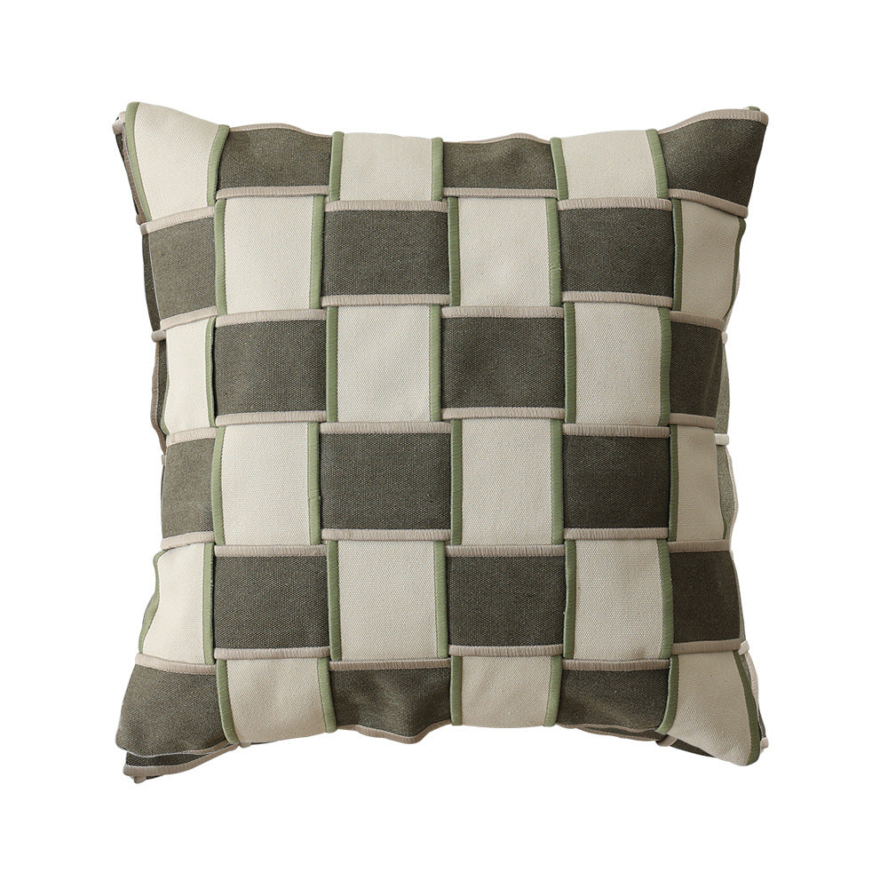 Decorative cushion cover with woven grid relief and contrasting piping