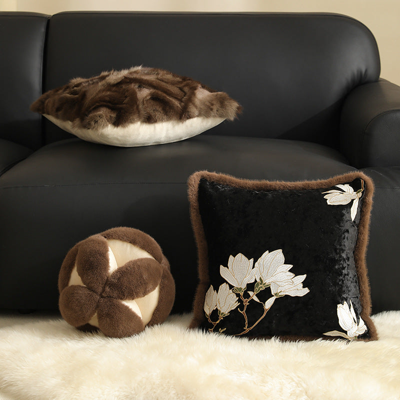 Square velvet decorative cushion with embroidered magnolia motif and faux fur border