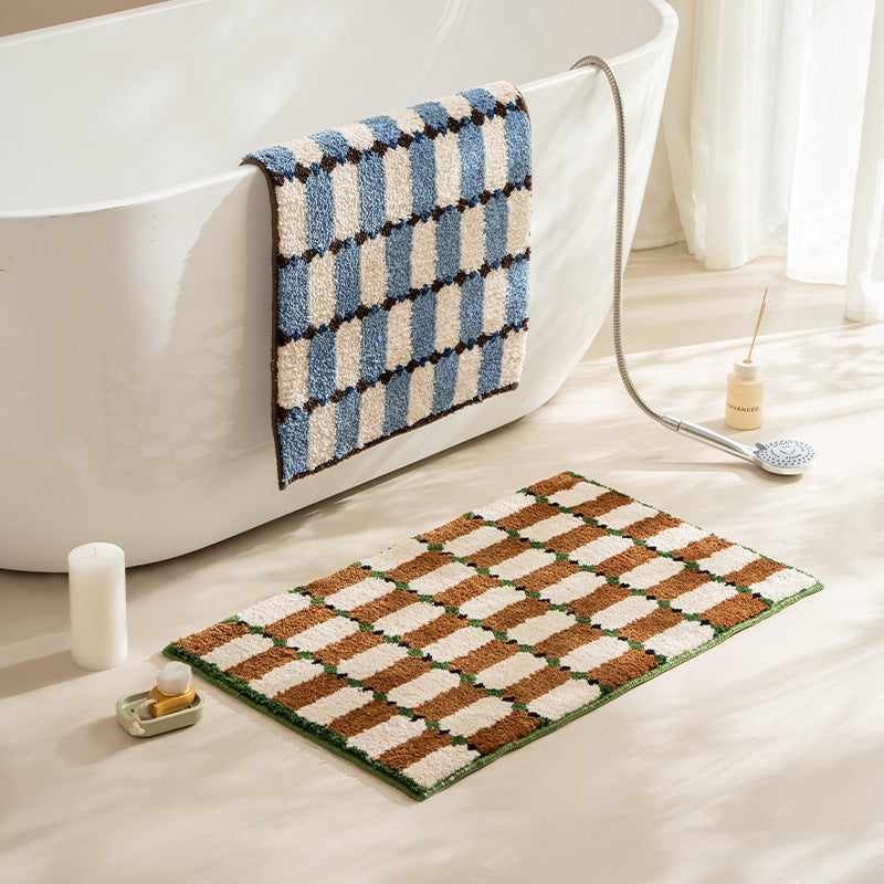Hand-tufted bathroom mat with a velvety pile, non-slip latex backing, and geometric honeycomb check pattern