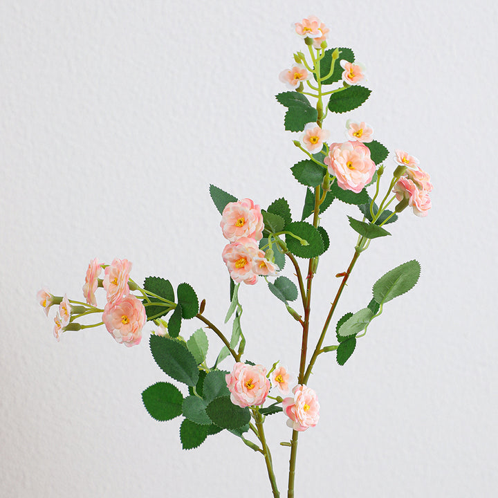 Artificial branch with decorative flowers