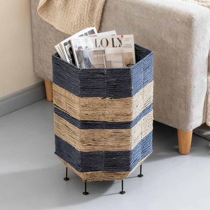 Stylish laundry basket made of rattan with metal legs