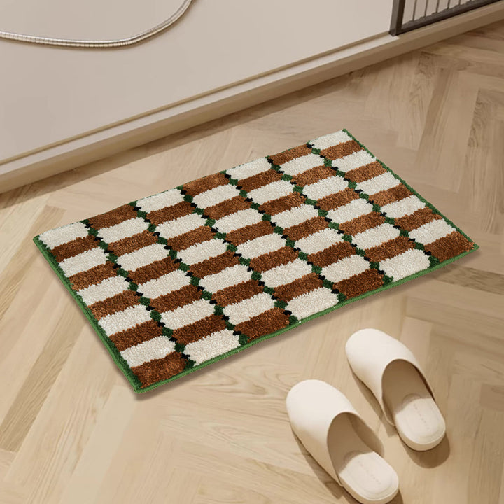 Hand-tufted bathroom mat with a velvety pile, non-slip latex backing, and geometric honeycomb check pattern