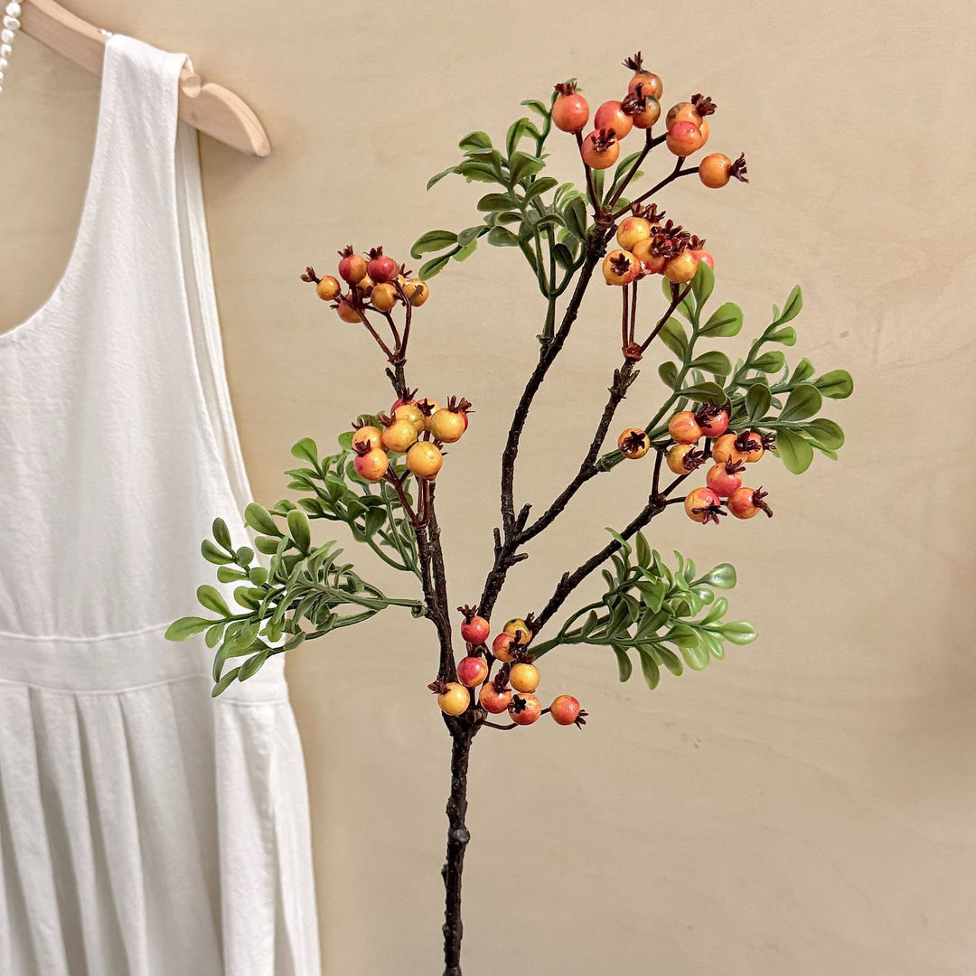 Artificial branch with glowing berries and green