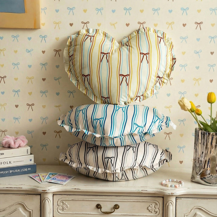 Heart-shaped decorative pillow with ruffled edge and heart pattern