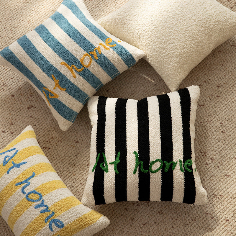 Striped bouclé decorative pillow with embroidered lettering and cuddly filling