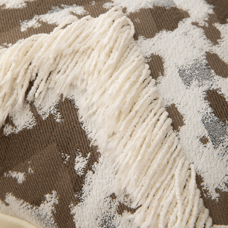 Woven square decorative cushion with fringe application and geometric pattern