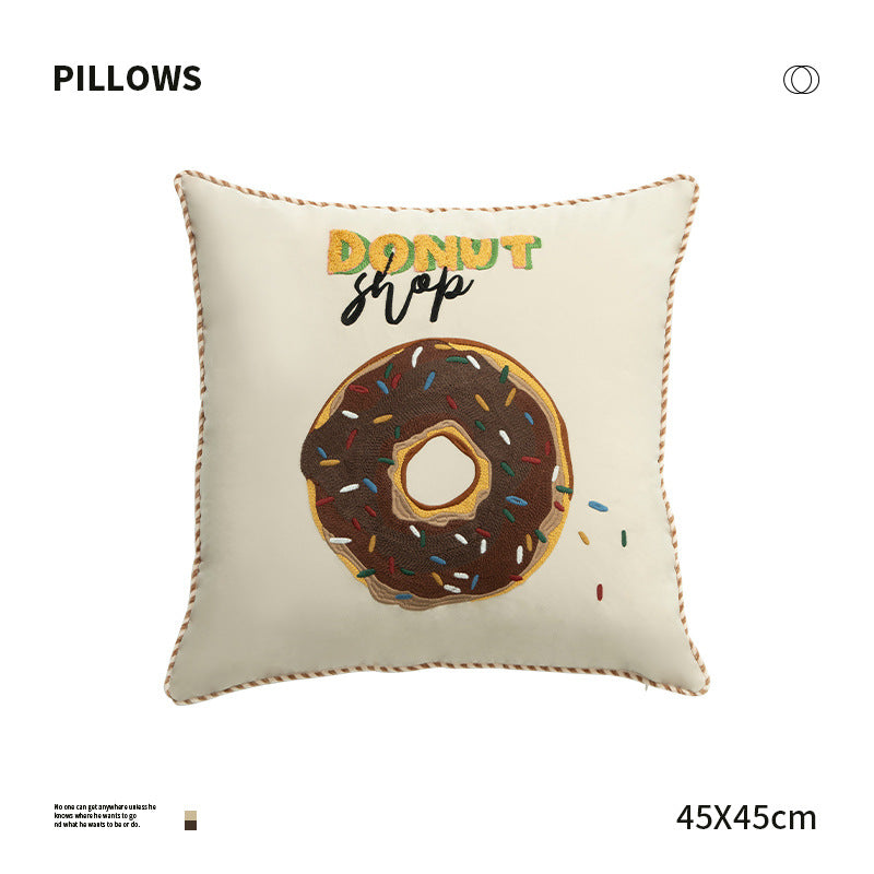 Square decorative cushion with embroidered donut motif and decorative piping edge