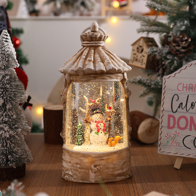 Illuminated Christmas lantern with snow scenes