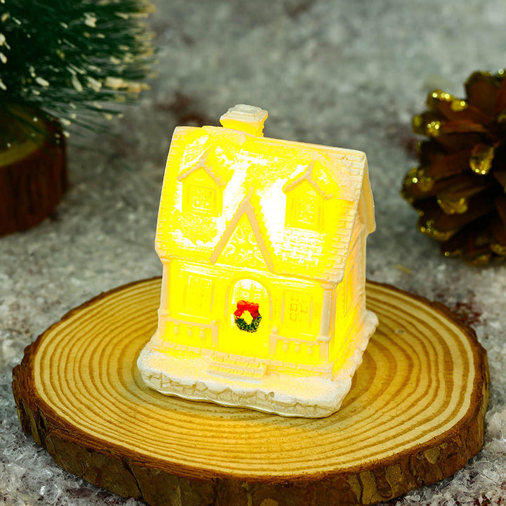 Illuminated Christmas village house with festive decoration
