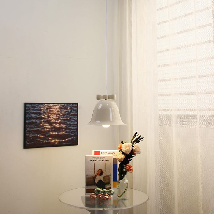 Bell-shaped glass pendant lamp with decorative bow accent
