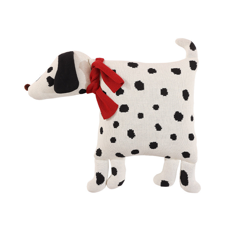 Decorative knitted cuddle pillow in the shape of a dog with a quilted body and bow detail