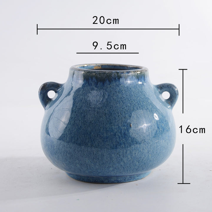 Decorative ceramic pot with playful handles
