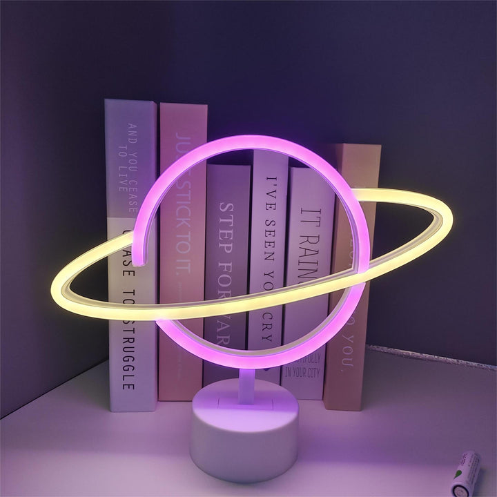 Saturn-inspired LED orb table lamp with dual-colored neon rings