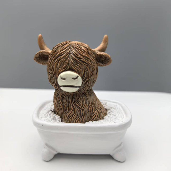 Funny decorative figure of a Highland cow in a bathtub