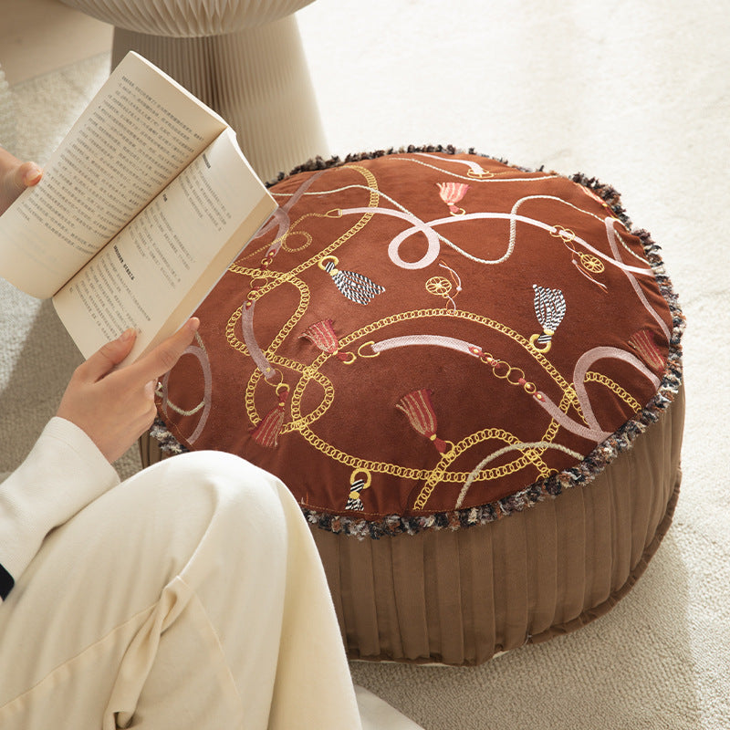 Round decorative floor cushion pouf with velvety printed top, pleated side wall, and fringe edge