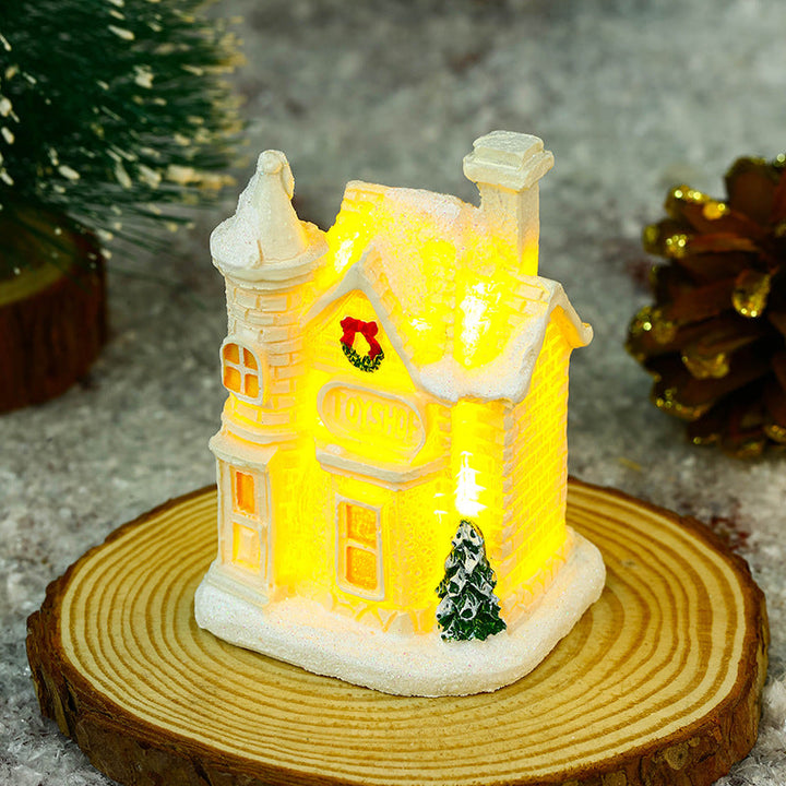 Illuminated Christmas village house with festive decoration