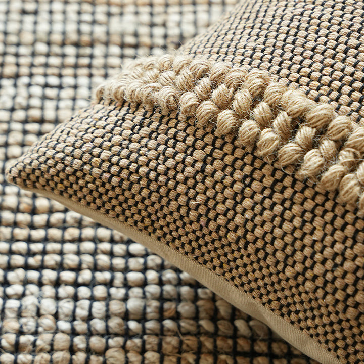 Handwoven structured cushion cover made of cotton blend with pompom trim