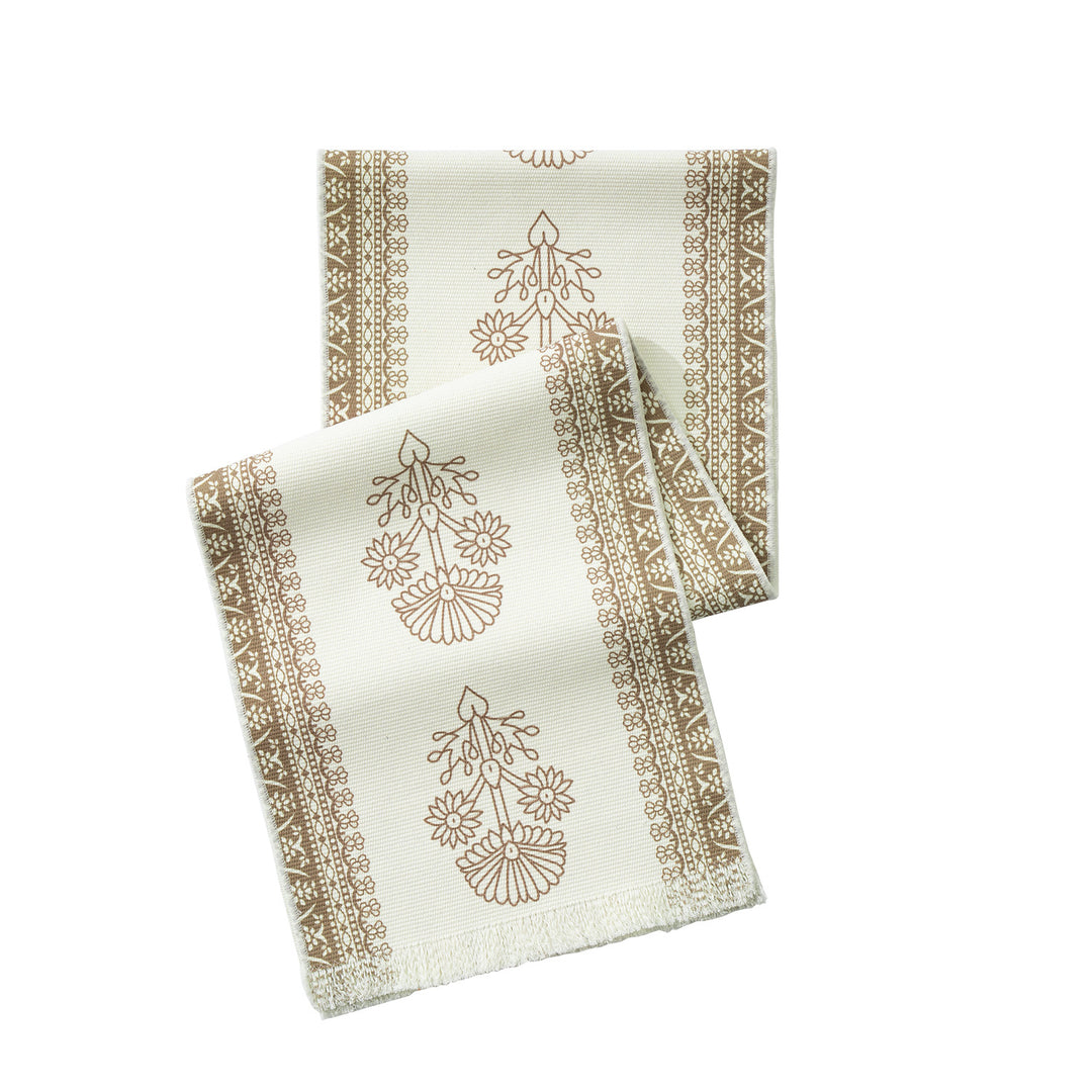 Woven decorative table runner with floral medallion borders and fringes