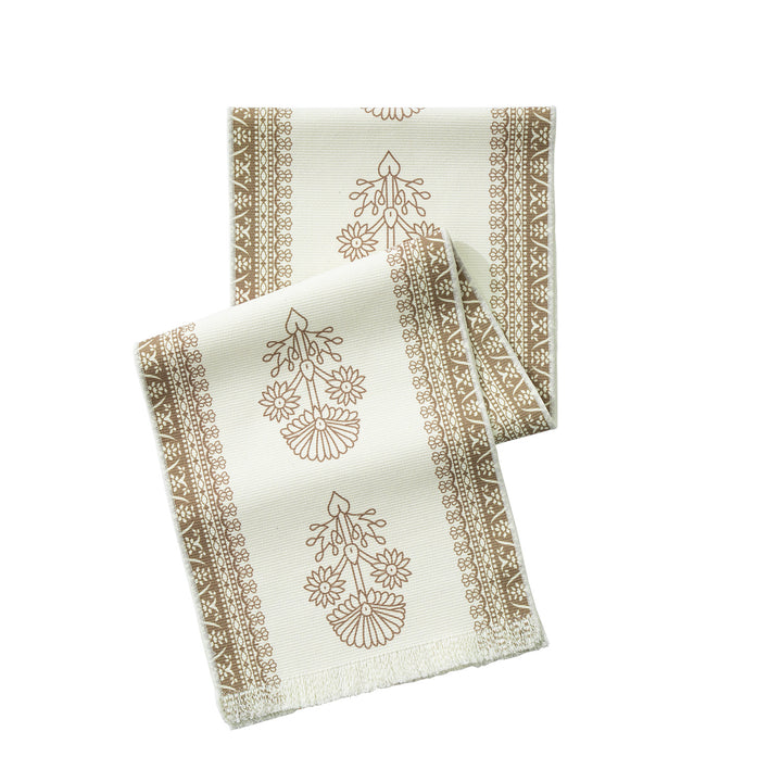 Woven decorative table runner with floral medallion borders and fringes