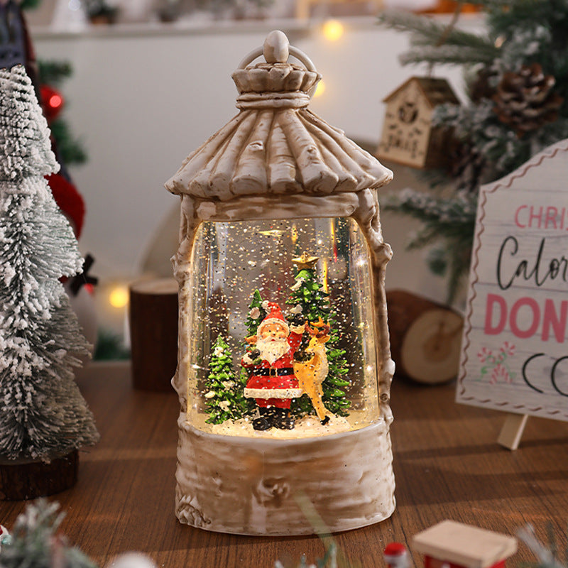 Illuminated Christmas lantern with snow scenes