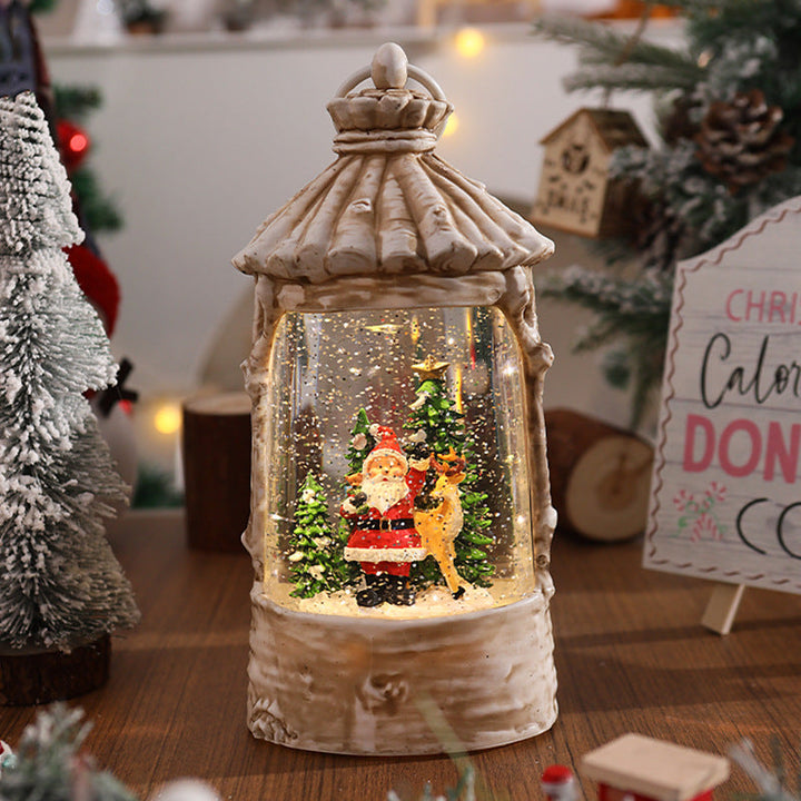 Illuminated Christmas lantern with snow scenes