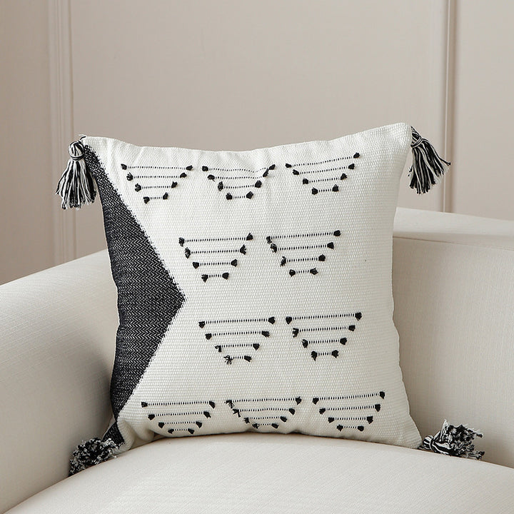 Decorative woven cushion cover with geometric tuft-relief and tassels