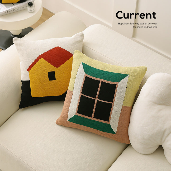 Geometric knit pillow with triangle pattern and logo patch