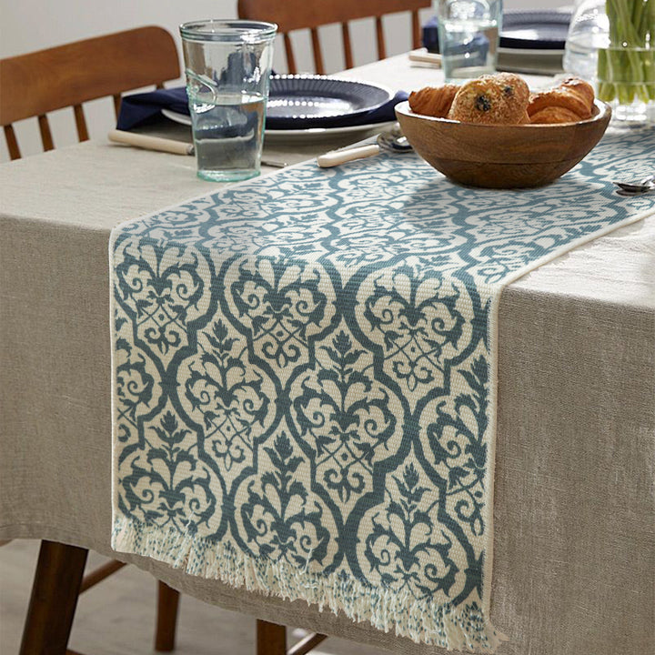 Woven table runner with flower jacquard, fringes and cotton blend