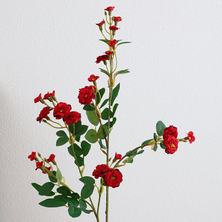 Artificial branch with decorative flowers
