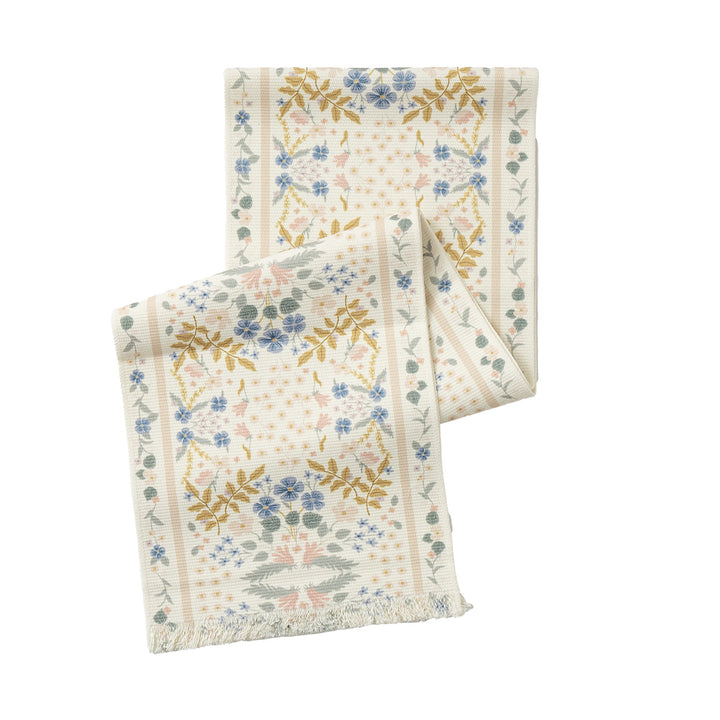 Vintage-inspired woven table runner with floral border and fringes