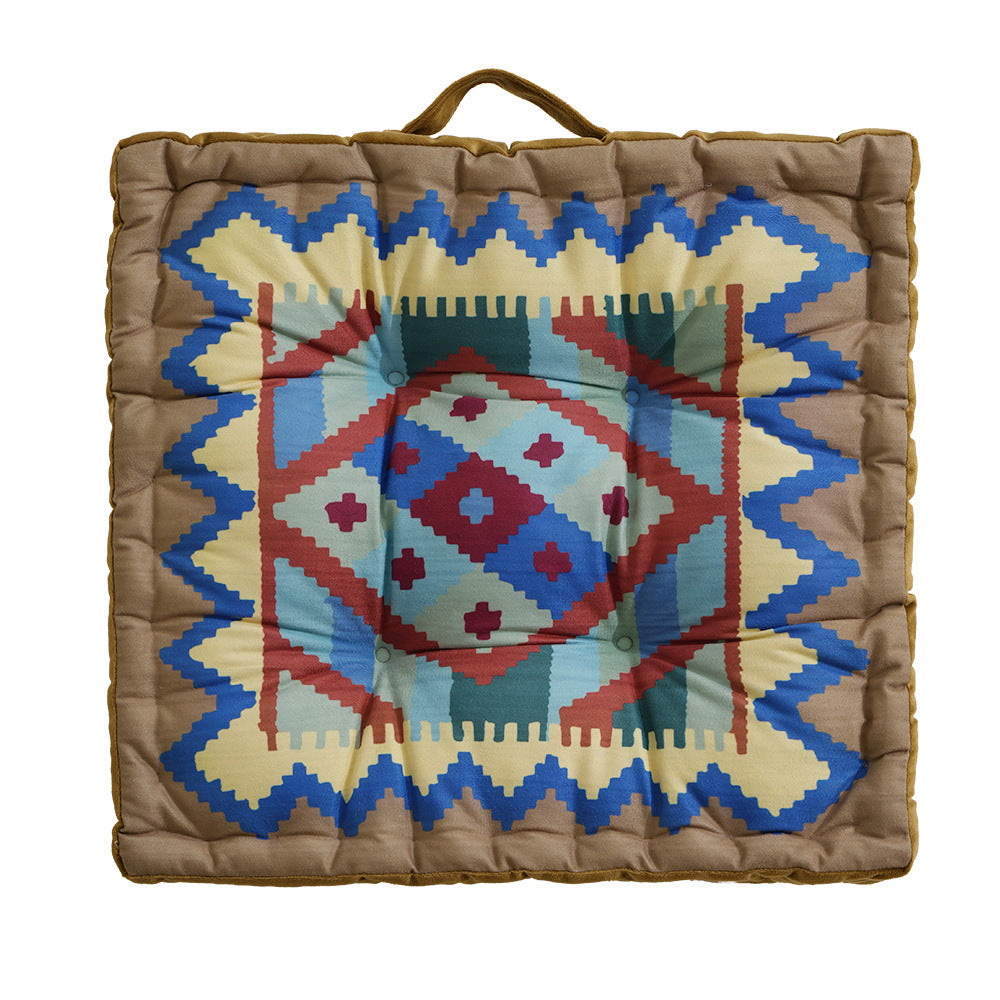 Padded seat and floor cushion with carrying handle and graphic ethno pattern