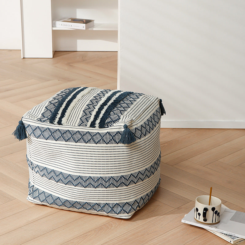 Braided square floor seat pouf with tassels and woven ethnic pattern