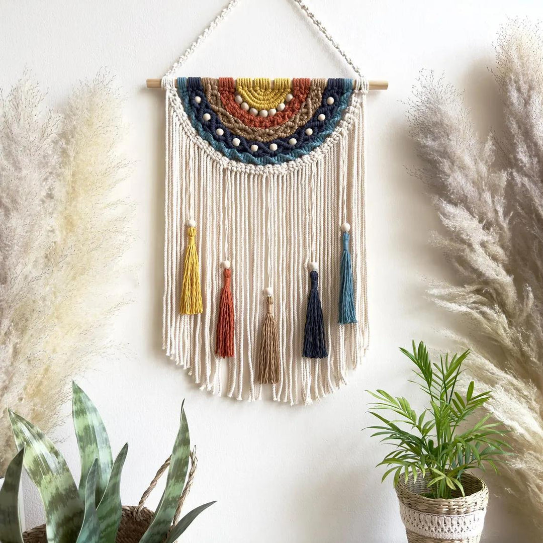 Artistic macrame wall hanging with colorful tassels and decorative elements