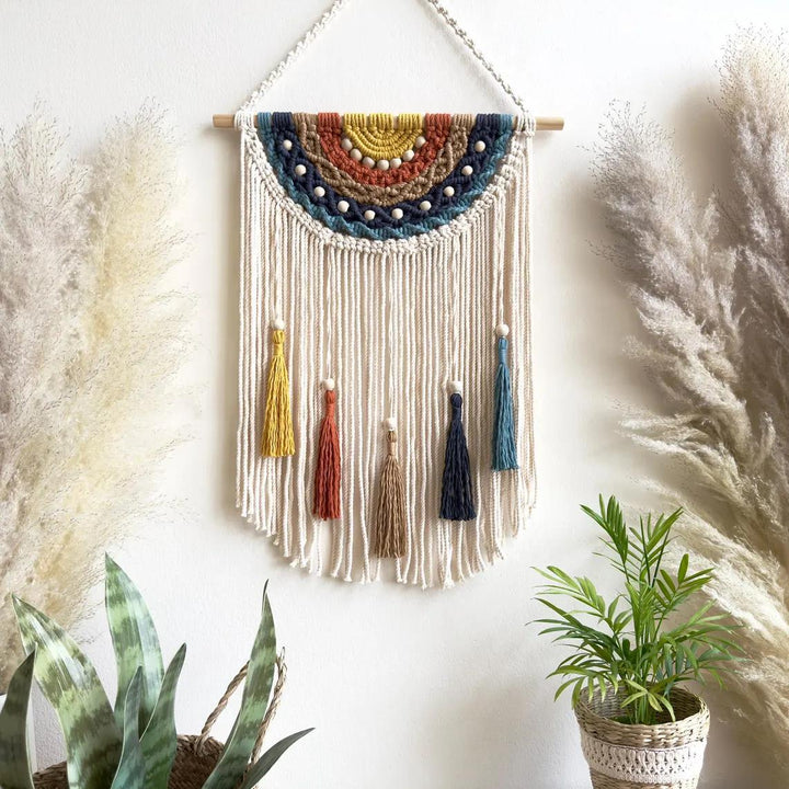 Artistic macrame wall hanging with colorful tassels and decorative elements