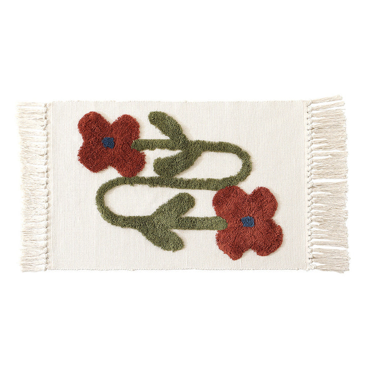 Handwoven cotton bath mat rug with tufted flower appliqué and tassels
