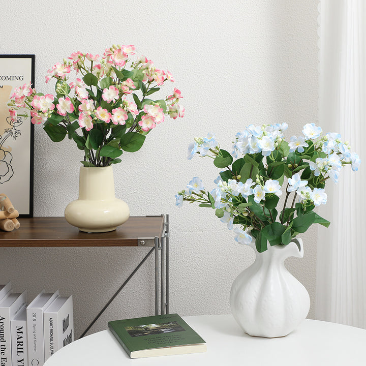 Artificial flower branch with vibrant pink flowers