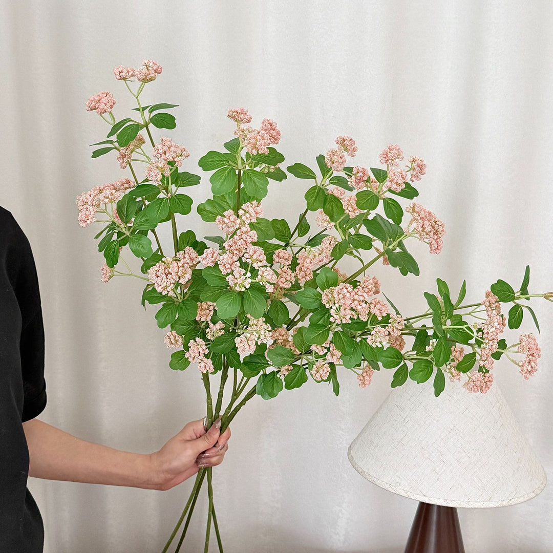 Artificial blossom branch with purple flowers