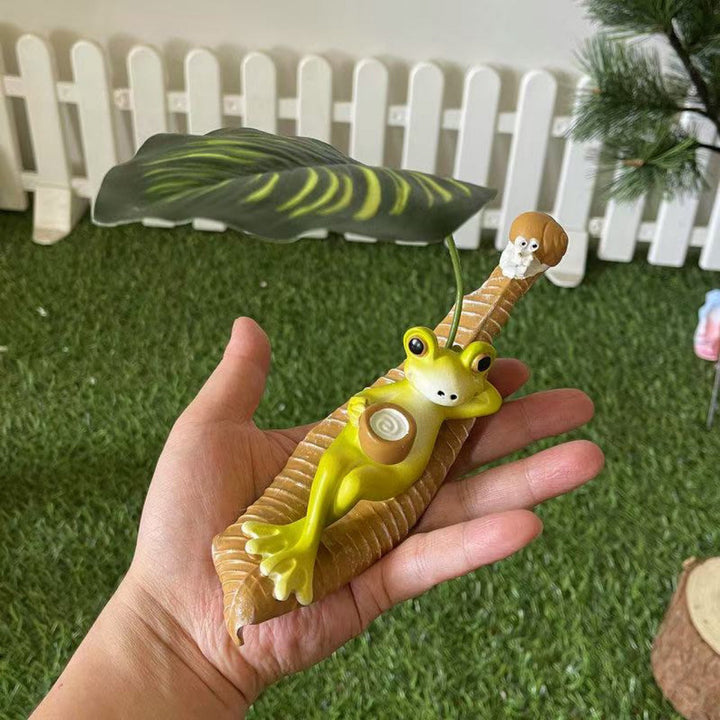 Funny frog figure with leaf decor