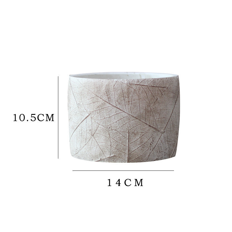 Decorative plant container made of handmade ceramic with leaf pattern